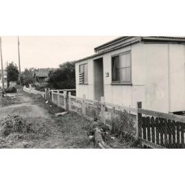 Nature strip in front of cottage on unidentified street, c1940s