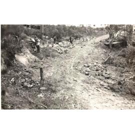 Labourers continue with roadworks, unidentified site, c1940s