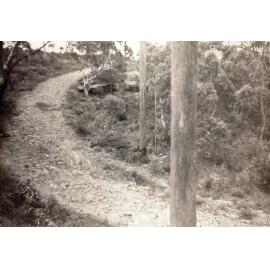 Steep rocky unsealed road surface, c1940s