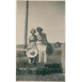 Two women sitting on a fence, Narrabeen, 1943