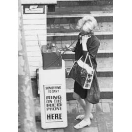 Lady making a call on a public Red Phone, Manly, c1967-1973