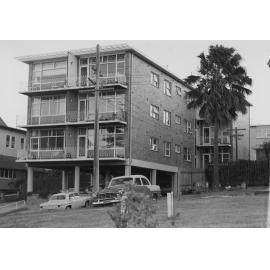 Brick apartment building with balconies and under-building parking, Manly, c1967-1973