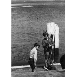 Man and two boys fishing at Manly Wharf, Manly, c1967-1973