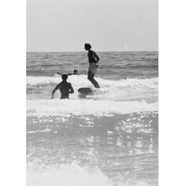 Surfers in the shallows at Manly Beach, Manly, 1972