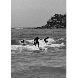Surfers near the rocks at Manly Beach, Manly, 1972