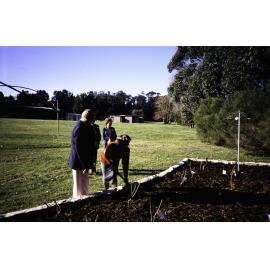 Two individuals planting at the opening of the Nelson Heather Centre Bicentennial Rose Garden, Warriewood, 1988